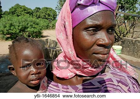 Woman and child on hip Berending village south of The Gambia View Large Photo Image Picture - Woman and child on hip Berending village south of The Gambia. Fotosearch