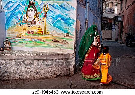 Woman and child passing through an beautifully painted alley. Jodhpur, Rajasthan, India. View Large Photo Image Stock Image - Woman and child passing through an beautifully painted alley. Jodhpur, Rajasthan, India.. Fotosearch