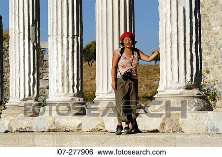 Stock Photograph - Woman and columns of Miletus. Turkey. Fotosearch