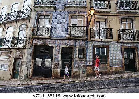 Woman and daughter walking in Alfama, Lisbon, Portugal View Large Photo Image Stock Photograph - Woman and daughter walking in Alfama, Lisbon, Portugal. Fotosearch