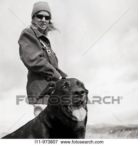 Woman and dog walking on cold, cloudy day View Large Photo Image Stock Photo - Woman and dog walking on cold, cloudy day. Fotosearch