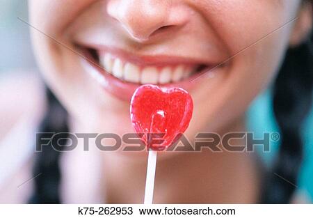 woman and her heart shaped lollipop View Large Photo Image Stock Image - woman and her heart shaped lollipop. Fotosearch