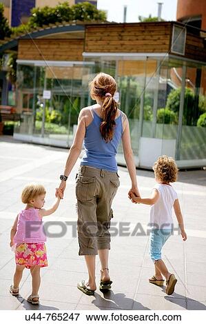 Stock Photo - Woman and her two daughter at the mall. Fotosearch