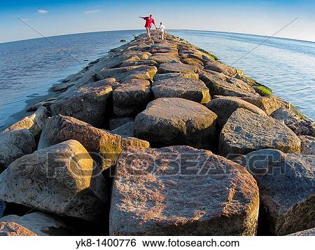 Woman and Kid Boy Walking Away on Stony Pier in P? rnu, Estonia View Large Photo Image Stock Photograph - Woman and Kid Boy Walking Away on Stony Pier in P? rnu, Estonia. Fotosearch