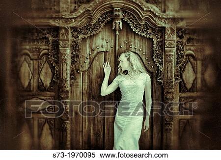 Stock Photography - Woman and old door. Fotosearch