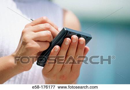 Stock Photo - Woman and palm pilot. Fotosearch