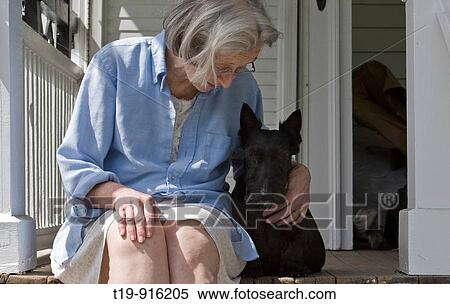 Woman and Scottish Terrier enjoying a sunny summer morning on the porch MR & PR View Large Photo Image Stock Photography - Woman and Scottish Terrier enjoying a sunny summer morning on the porch MR & PR. Fotosearch