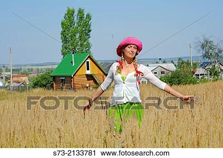 Woman and traditional russian house, Kuz? kino, Russian Federation View Large Photo Image Stock Image - Woman and traditional russian house, Kuz? kino, Russian Federation. Fotosearch