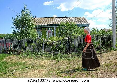 Woman and traditional russian house, Kuz? kino, Russian Federation View Large Photo Image Stock Photo - Woman and traditional russian house, Kuz? kino, Russian Federation. Fotosearch