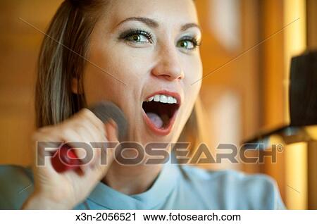 Woman applies makeup. View Large Photo Image Stock Image - Woman applies makeup.. Fotosearch