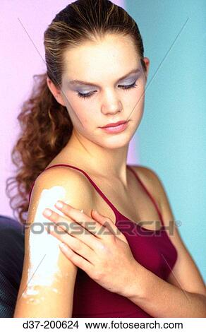 Woman applying cream onto arm View Large Photo Image Picture - Woman applying cream onto arm. Fotosearch