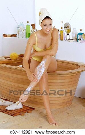 Woman applying cream onto legs View Large Photo Image Stock Image - Woman applying cream onto legs. Fotosearch