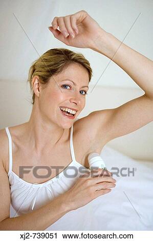 Woman applying deodorant View Large Photo Image Stock Image - Woman applying deodorant. Fotosearch