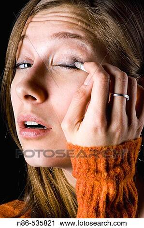Woman applying eye make-up View Large Photo Image Stock Image - Woman applying eye make-up. Fotosearch