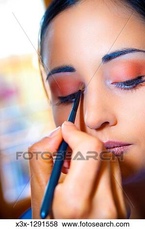 Woman applying eye shadow during make up session View Large Photo Image Stock Photo - Woman applying eye shadow during make up session. Fotosearch