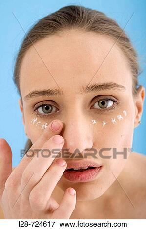 Stock Photo - Woman applying face cream, close-up. Fotosearch