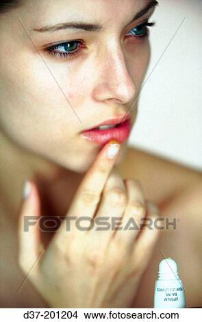 Picture - Woman applying facial cream. Fotosearch