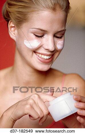 Woman applying facial cream View Large Photo Image Stock Photo - Woman applying facial cream. Fotosearch