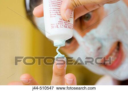 Woman applying green facial mask in the bathroom View Large Photo Image Stock Photo - Woman applying green facial mask in the bathroom. Fotosearch