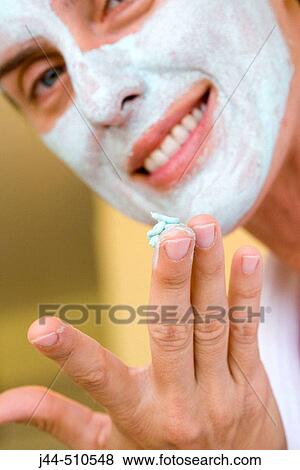 Woman applying green facial mask in the bathroom View Large Photo Image Stock Photo - Woman applying green facial mask in the bathroom. Fotosearch