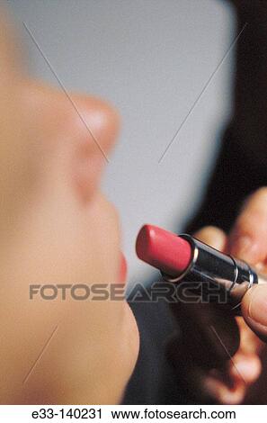 Woman applying lipstick View Large Photo Image Stock Image - Woman applying lipstick. Fotosearch