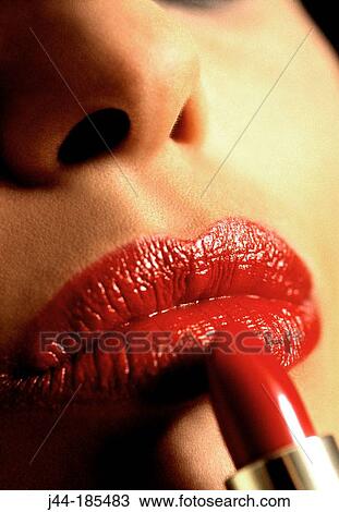 Woman applying lipstick View Large Photo Image Stock Image - Woman applying lipstick. Fotosearch