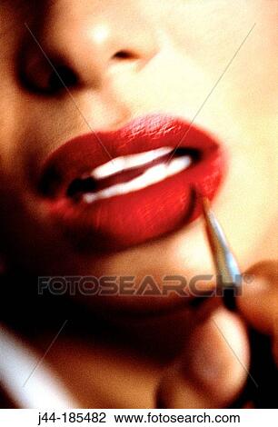 Woman applying make up on lips View Large Photo Image Stock Image - Woman applying make up on lips. Fotosearch