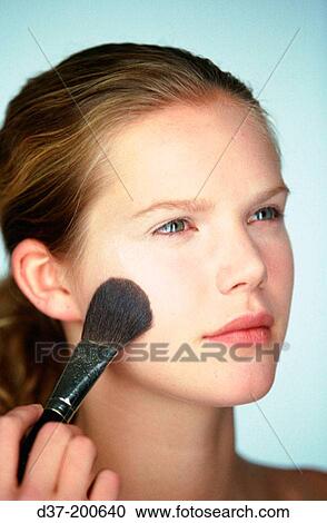Woman applying make-up View Large Photo Image Stock Image - Woman applying make-up. Fotosearch