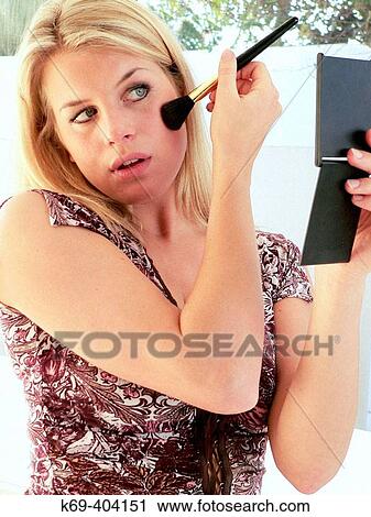 Woman applying make-up View Large Photo Image Stock Image - Woman applying make-up. Fotosearch