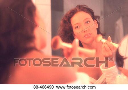 Stock Image - Woman applying make up. Fotosearch