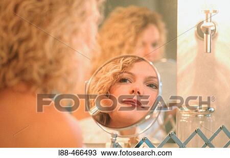 Stock Image - Woman applying make up. Fotosearch