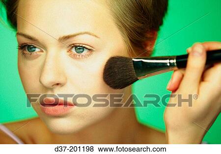 Woman applying make-up View Large Photo Image Stock Photo - Woman applying make-up. Fotosearch
