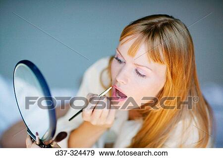 Stock Photo - Woman applying make-up. Fotosearch