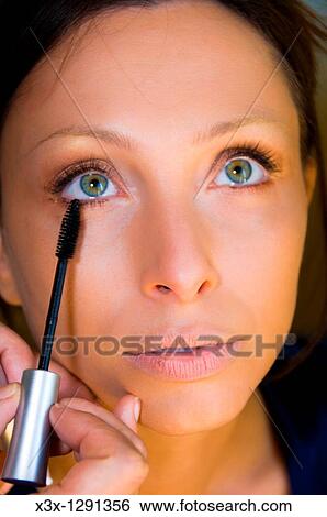 Woman applying mascara View Large Photo Image Stock Photograph - Woman applying mascara. Fotosearch
