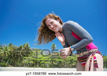 Woman applying sunblock at Playa Hermosa, Costa Rica. View Large Photo Image Stock Photo - Woman applying sunblock at Playa Hermosa, Costa Rica.. Fotosearch