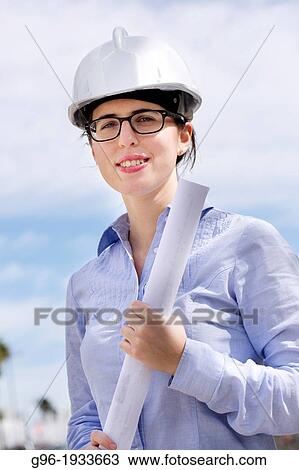 Woman architect with plans and helmet. View Large Photo Image Stock Image - Woman architect with plans and helmet.. Fotosearch