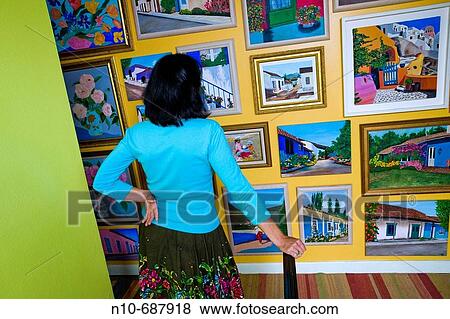 Woman artist, in her house, standing in front of her paintings. View Large Photo Image Stock Photo - Woman artist, in her house, standing in front of her paintings.. Fotosearch