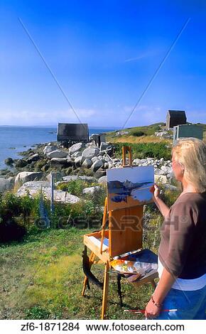 Woman artist painting scenic in Peggy's Cove area in Nova Scotia Canada View Large Photo Image Picture - Woman artist painting scenic in Peggy's Cove area in Nova Scotia Canada. Fotosearch