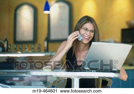 woman at a cafe with lap top and cell phone View Large Photo Image Stock Image - woman at a cafe with lap top and cell phone. Fotosearch