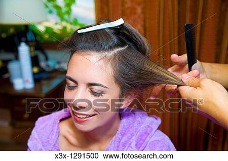 Woman at a salon during hair styling View Large Photo Image Stock Image - Woman at a salon during hair styling. Fotosearch