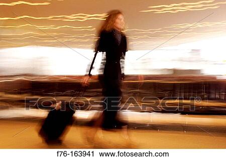 Stock Image - Woman at airport. Fotosearch