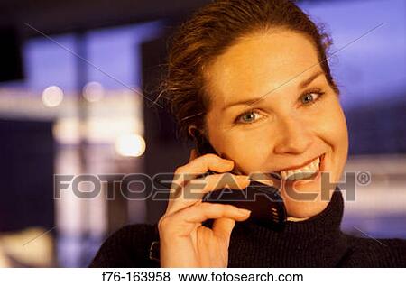 Woman at airport with cell phone View Large Photo Image Stock Photo - Woman at airport with cell phone. Fotosearch