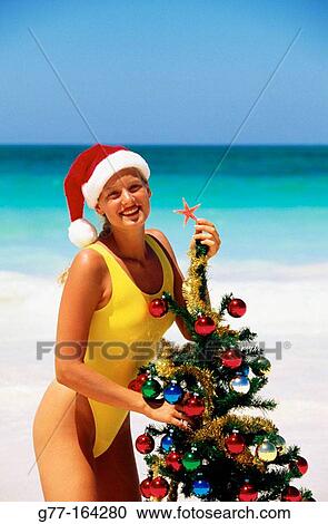 Stock Image - Woman at beach in Christmas. Dominican Republic. Fotosearch