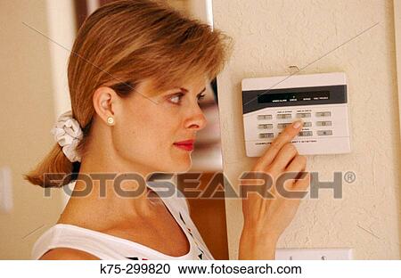 woman at her home alarm system View Large Photo Image Stock Image - woman at her home alarm system. Fotosearch
