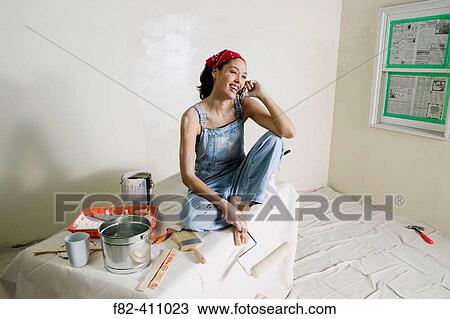 Stock Image - Woman at home painting. Fotosearch