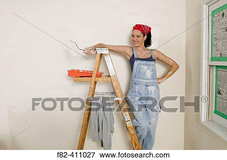 Woman at home painting View Large Photo Image Stock Photo - Woman at home painting. Fotosearch