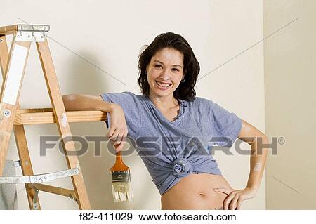 Woman at home painting View Large Photo Image Stock Photo - Woman at home painting. Fotosearch