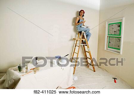 Stock Photography - Woman at home painting. Fotosearch