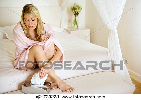 Woman at home taking a tissu View Large Photo Image Stock Image - Woman at home taking a tissu. Fotosearch