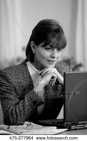 Woman at laptop View Large Photo Image Picture - Woman at laptop. Fotosearch